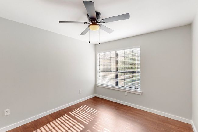Unfurnished room with wood finished floors, ceiling fan, and baseboards | Image 26