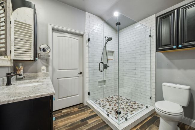 Full Bathroom with Glass-enclosed Shower with Floor-to-Ceiling Tile | Image 34