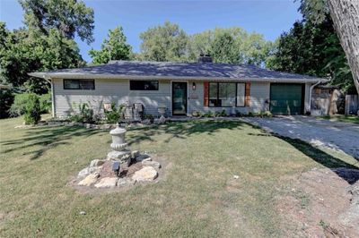 Ranch-style house with a garage and a front lawn | Image 1