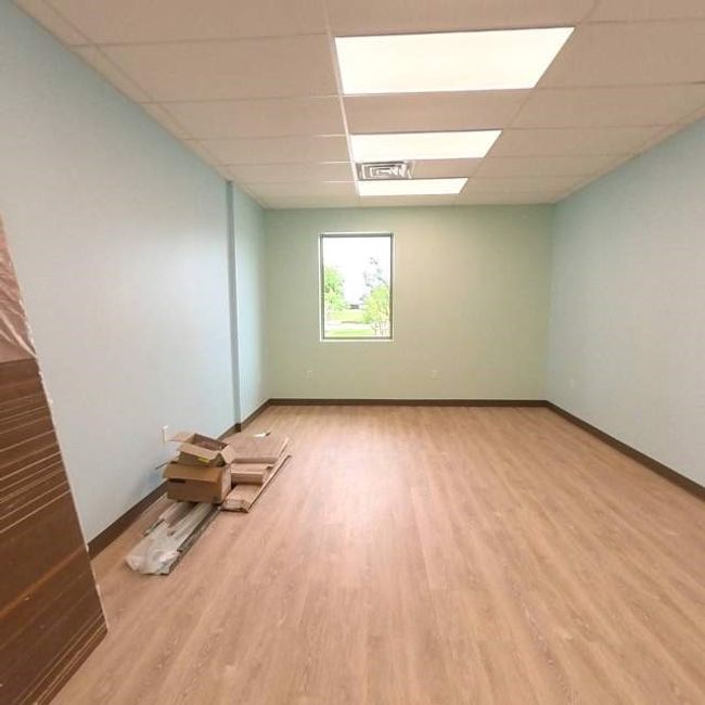 Unfurnished room with light wood-type flooring, a paneled ceiling, and baseboards | Image 10