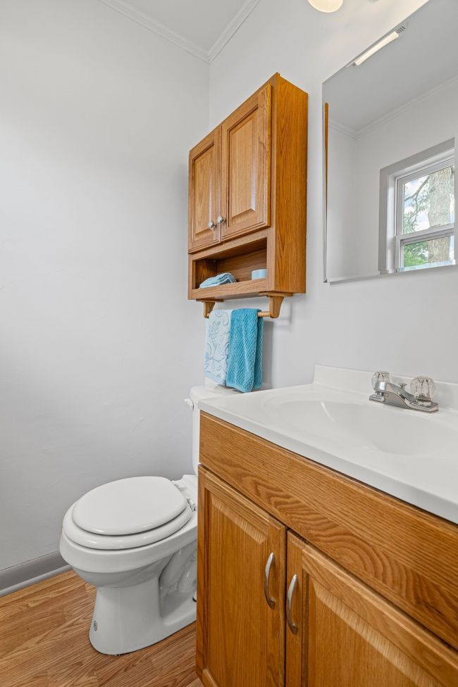 Bathroom featuring vanity, ornamental molding, and wood finished floors | Image 30