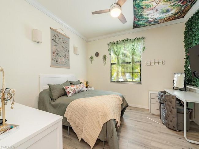 Bedroom featuring light wood-style floors, ceiling fan, baseboards, and crown molding | Image 7