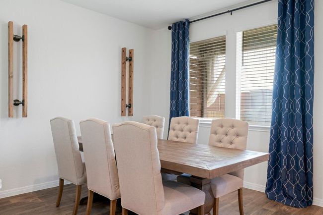 Dining space featuring baseboards and wood finished floors | Image 8