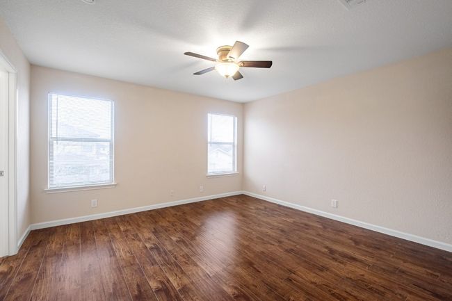 Unfurnished room with healthy amount of natural light, ceiling fan, and dark wood finished floors | Image 21