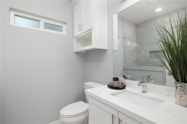 Full bathroom with vanity and a marble finish shower | Image 12