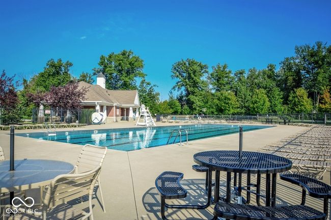 community pool with a patio area | Image 38