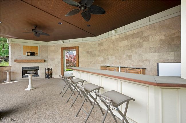 View of patio / terrace with a ceiling fan and fireplace | Image 48