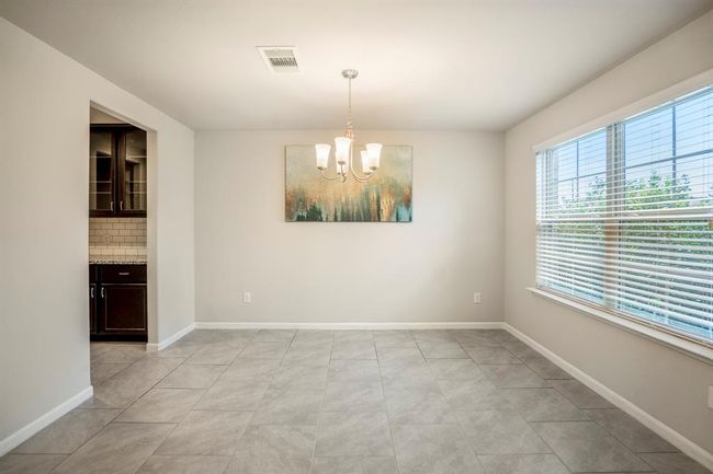 The formal dining room has plenty of space for your entertainment needs with lots of windows that offer natural light. | Image 4