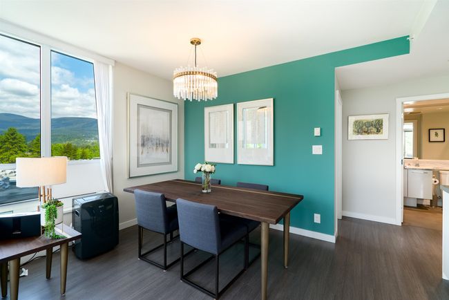 Dining space with dark wood-style flooring, a chandelier, a mountain view, and baseboards | Image 6
