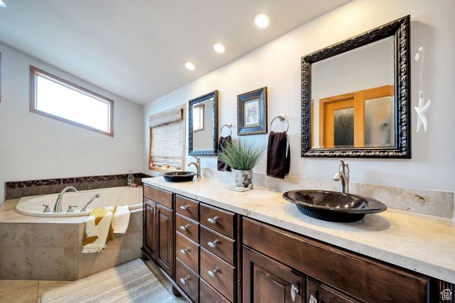 Bathroom featuring recessed lighting, a garden tub, double vanity, and a sink | Image 32