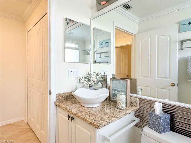Bathroom featuring ornamental molding, tile flooring, toilet, and vanity | Image 22