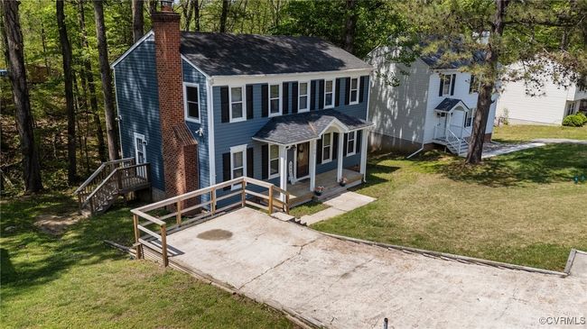 View of front of home with a front lawn, roof with shingles, and a chimney | Image 34