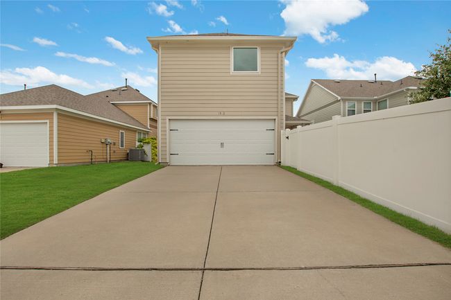Rear view of house with a garage and concrete driveway | Image 35