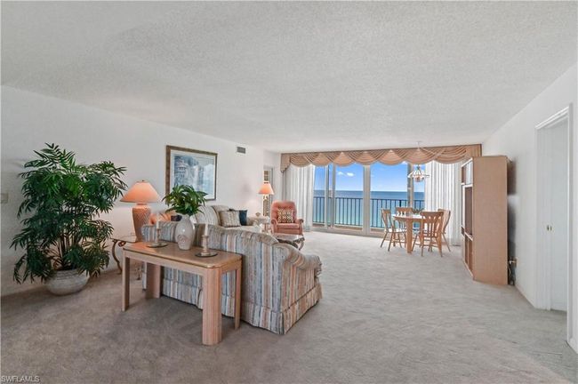 To the right of entry is livingroom with GULF views! | Image 3