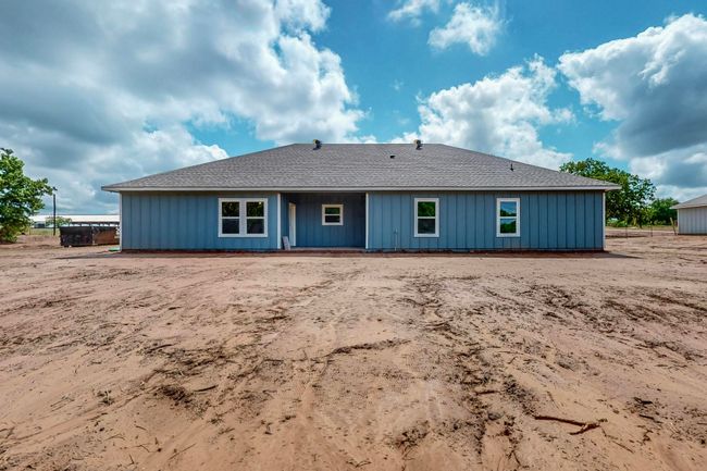 Rear view of property featuring roof with shingles and board and batten siding | Image 10