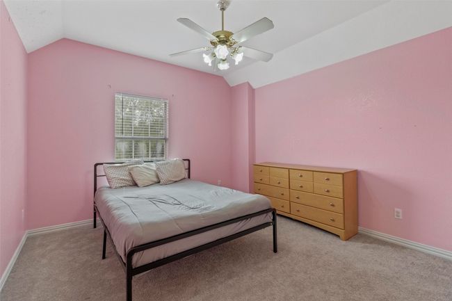 Bedroom featuring vaulted ceiling, light colored carpet, and a ceiling fan | Image 26
