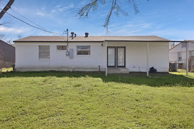 Rear view of property with a lawn, brick siding, and fence | Image 24