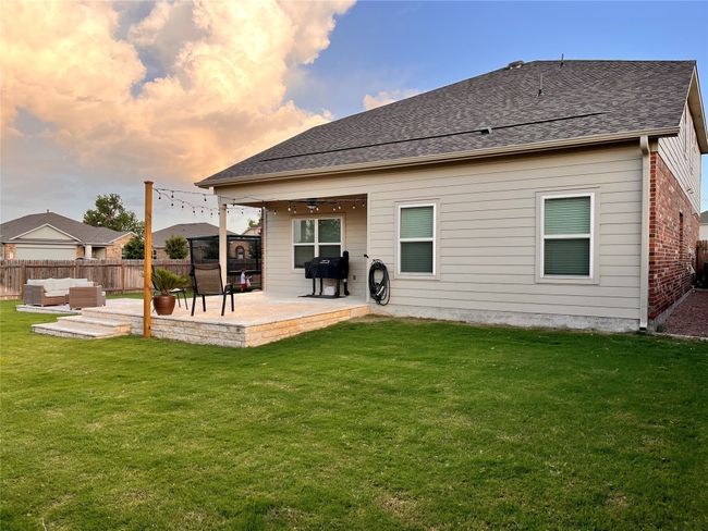 Back of house featuring an outdoor living space, a patio, and a shingled roof | Image 36