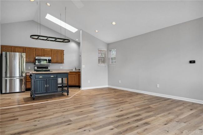 living room with vaulted ceiling | Image 22