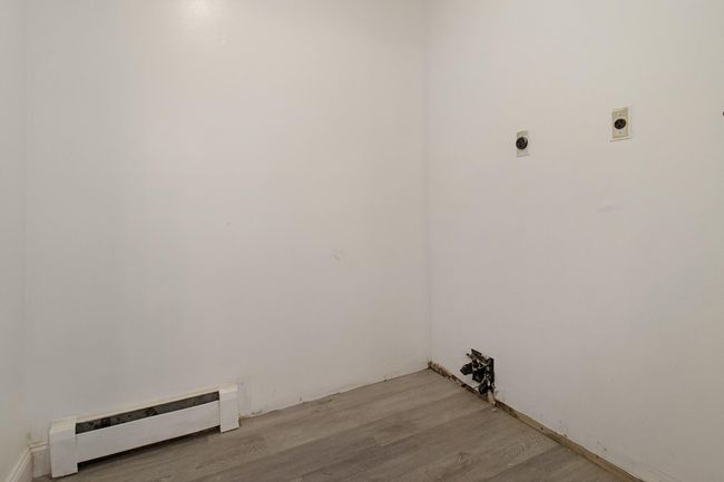 Laundry area featuring hookup for an electric dryer, a baseboard heating unit, and light wood-type flooring | Image 29