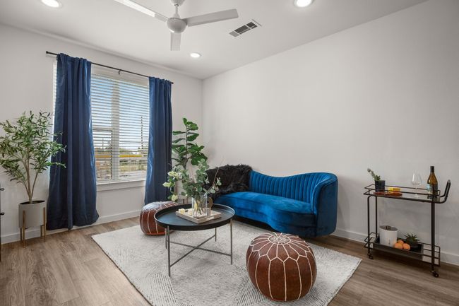 Living room is cozy and bright. *Photos are of similar unit* | Image 4