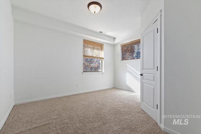 Unfurnished bedroom with baseboards and carpet | Image 43