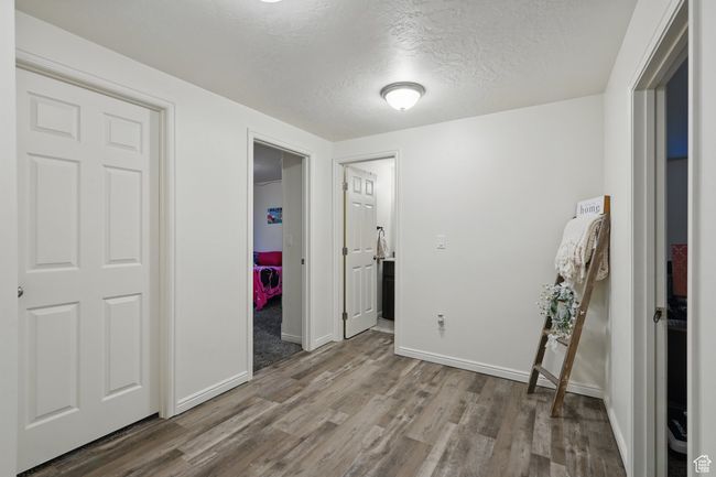 Unfurnished bedroom featuring a textured ceiling, wood finished floors, and baseboards | Image 38