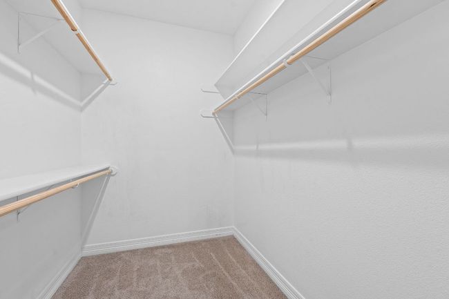 Spacious closet with light carpet | Image 30