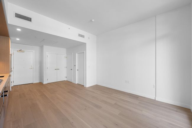 Unfurnished living room featuring light wood-style floors and recessed lighting | Image 6