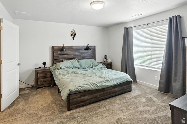 Carpeted primary bedroom | Image 11