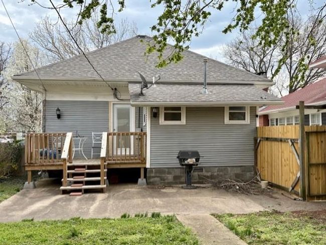 Rear view of house featuring fence, roof with shingles, and a wooden deck | Image 29