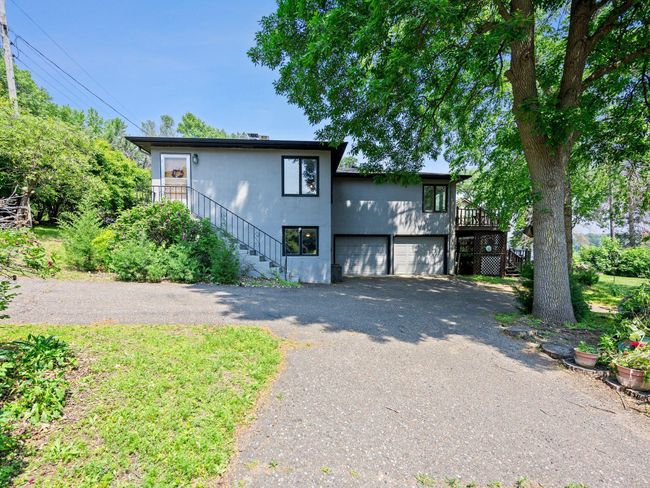 ...a large driveway with extra parking pad for guests or recreational vehicles, and an included dock and negotiable paddle boat. | Image 24