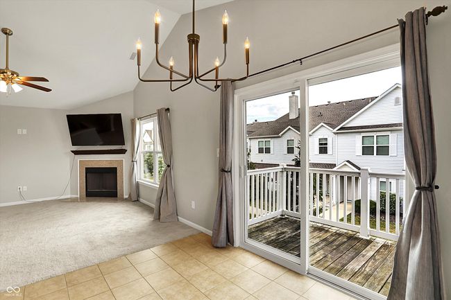 unfurnished dining area featuring a chandelier, and tile flooring. Open to the living room. | Image 18