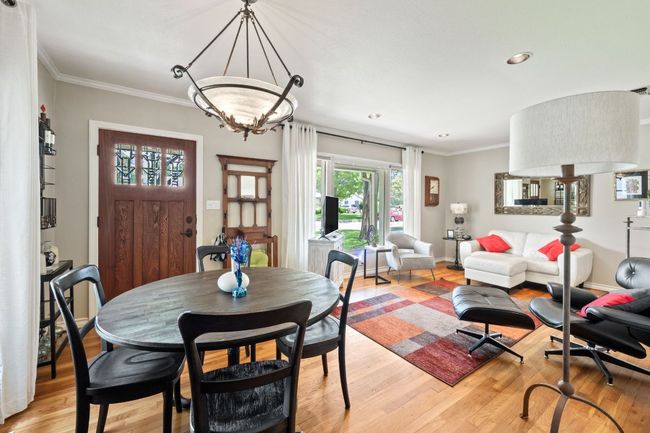 Dining room with light wood-style flooring, crown molding, and recessed lighting | Image 4