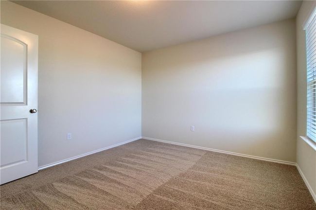 Spare room featuring carpet floors and baseboards | Image 33