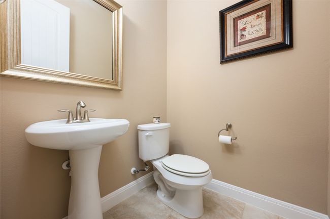 Half bathroom featuring toilet and tile patterned floors | Image 30