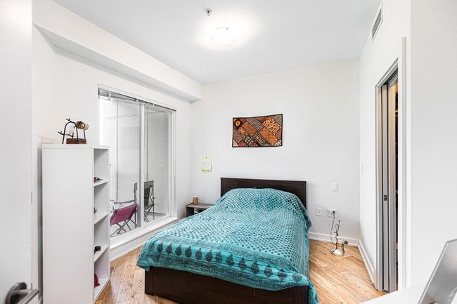 Bedroom featuring wood finished floors and baseboards | Image 7