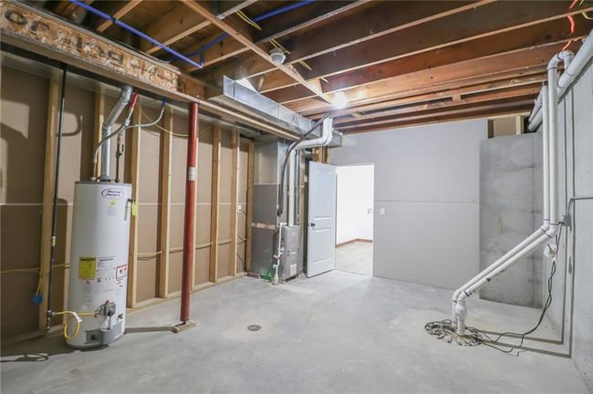 Basement with water heater and heating unit | Image 47