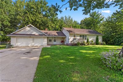 Ranch-style house featuring a garage and a front yard | Image 2