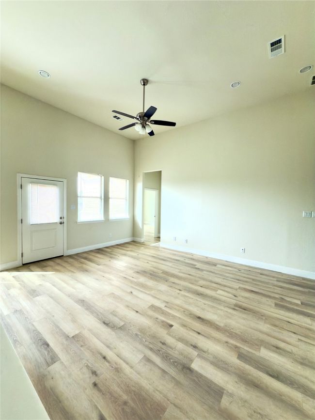 Empty room featuring ceiling fan, light wood-style floors, baseboards, and recessed lighting | Image 24