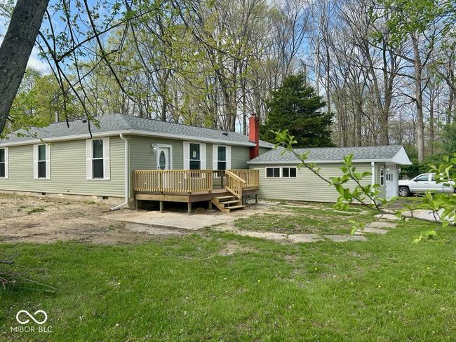 back of house featuring crawl space, a yard, a chimney, and a deck | Image 4