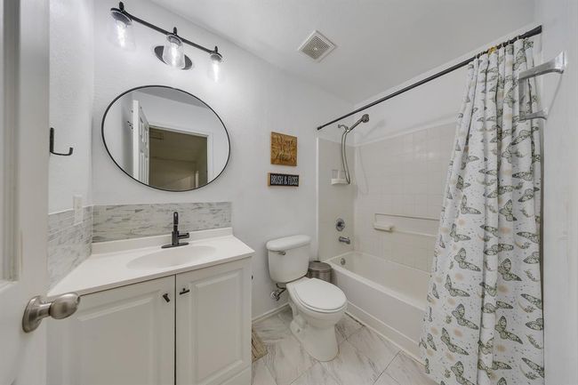 Second bathroom features stylish white and black details for a clean, modern look. | Image 30