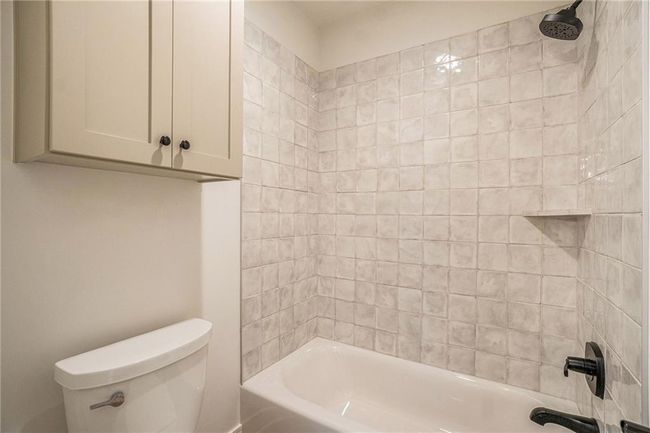 Bathroom with toilet and bathing tub / shower combination | Image 49
