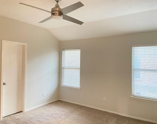 Empty room featuring vaulted ceiling, light carpet, and ceiling fan | Image 13