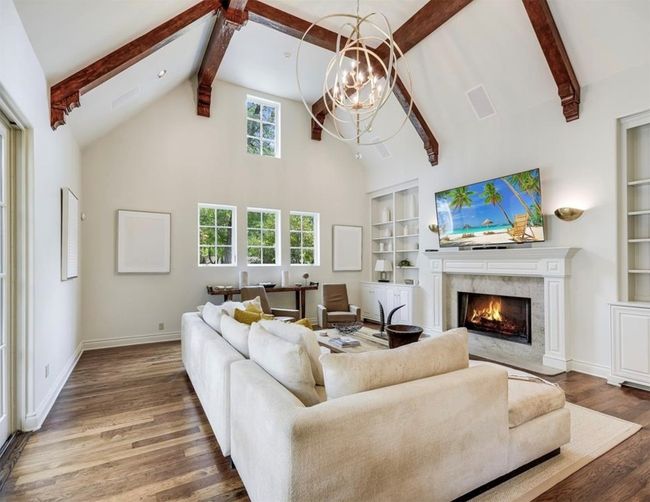 Living room with beamed ceiling and a second fireplace | Image 9