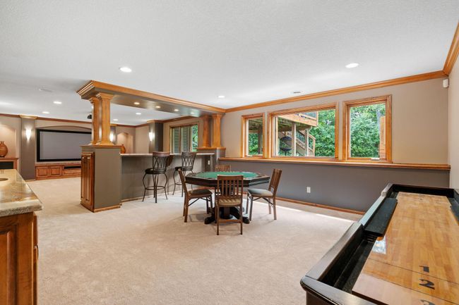 This space is perfect for entertaining or enjoying sports games on the big screen. | Image 31