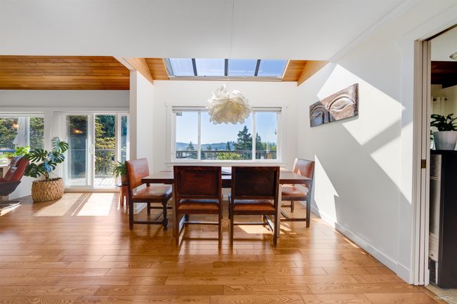 Dining space featuring wooden ceiling, plenty of natural light, and light wood-style flooring | Image 13