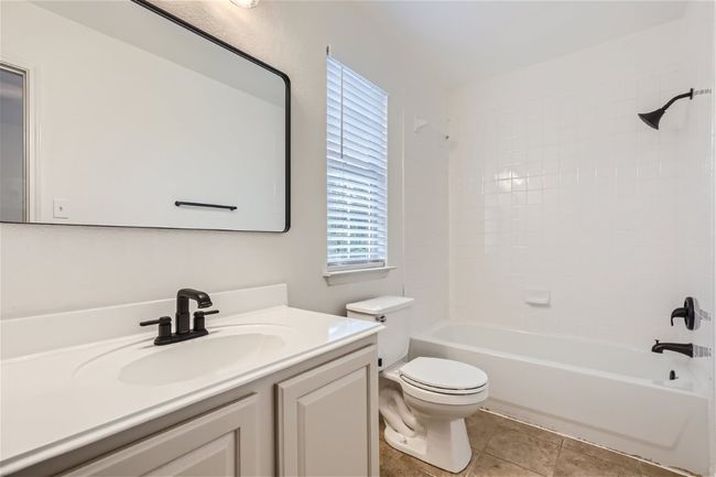 Bathroom featuring vanity, toilet, bathtub / shower combination, and tile patterned floors | Image 27