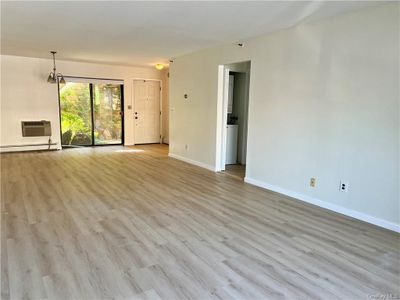 View of the expansive living room facing the dining area and entrance | Image 3