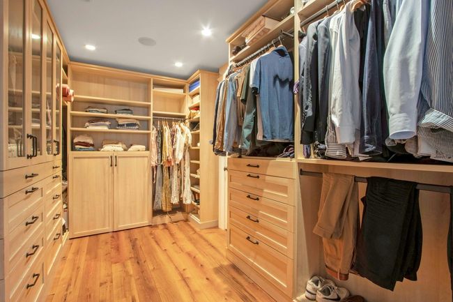 Walk in closet with light wood-style flooring | Image 23